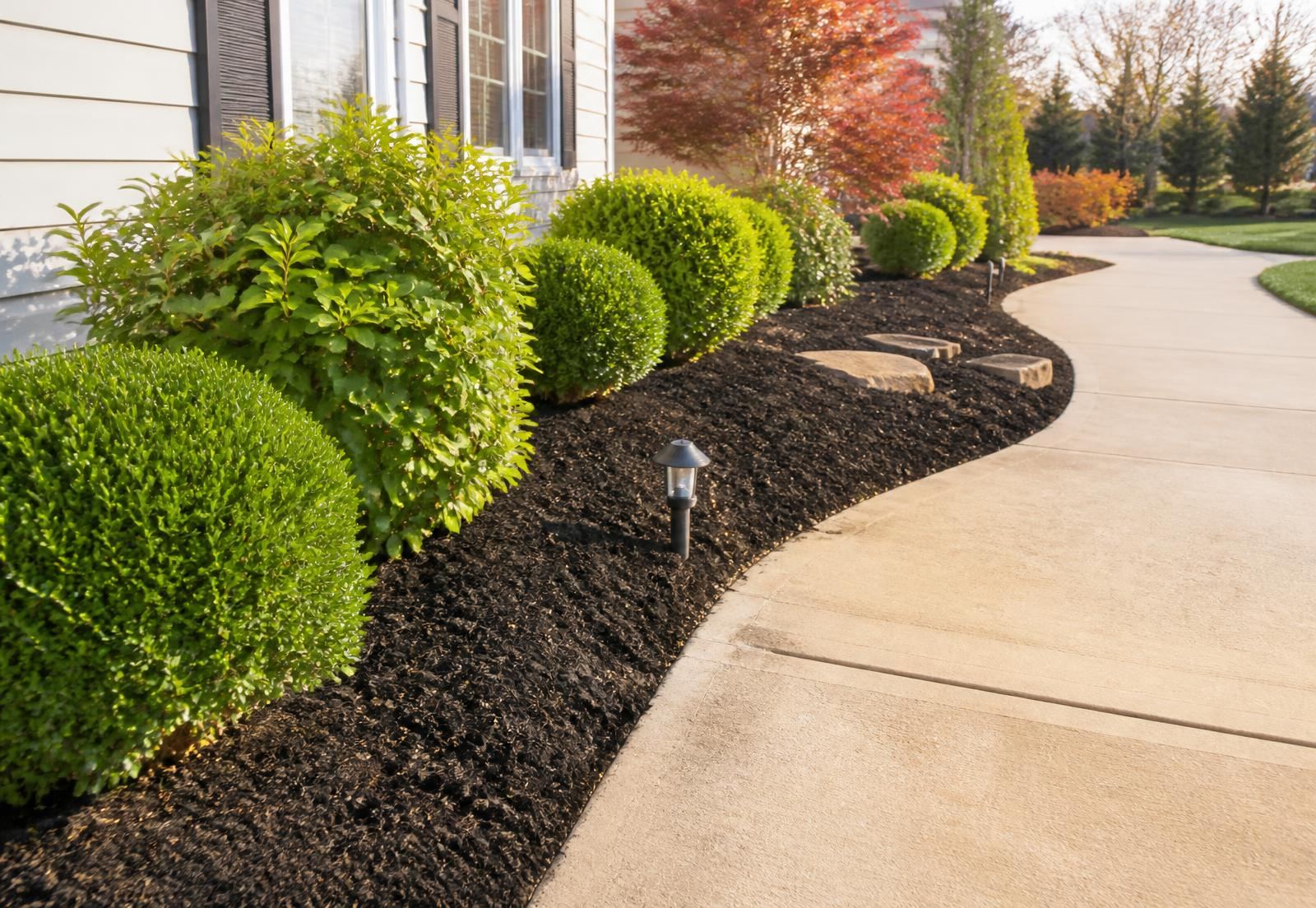 Freshly mulched planting beds with crisp edging along a walkway